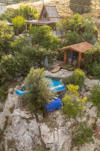 a backyard with a pool and a house and trees at Villa Mutaf in Kumluca