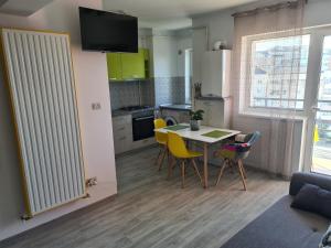 a kitchen and dining room with a table and chairs at Luxury Apartment Mall V in Bacău