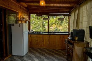 a kitchen with a white refrigerator and a sink at Villa Mutaf in Kumluca