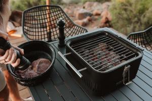 a black grill sitting on a table on a picnic table at Spionkop Eco Cabin in Reddersburg