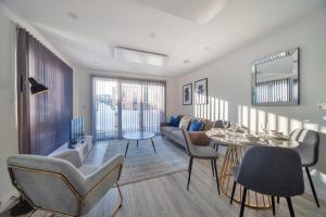 a living room with a couch and a table and chairs at Contemporary 2 Bedroom Apartment in Ashford in Ashford