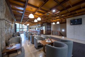 a restaurant with chairs and tables in a room at Hotel SOREA HUTNÍK I. in Vysoke Tatry - Tatranske Matliare