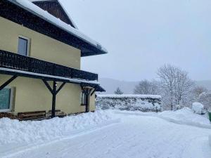 a snow covered house with a pile of snow at Art in Waldfrieden in Semmering