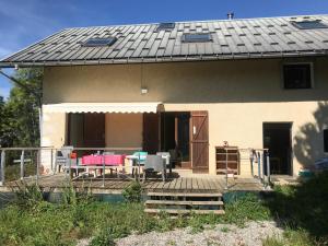 a house with a solar roof and a patio at Grande demeure familiale in Les Déserts