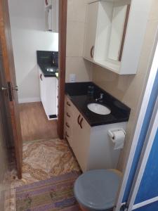 a small bathroom with a sink and a toilet at Residencial Vitor Studio 1 in São José dos Pinhais
