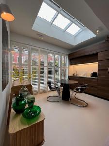 a kitchen with a skylight and a table and chairs at B&B Urban Oasis in Amsterdam