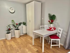 a dining room with a white table and two chairs at Grey House in Wrocław