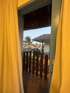 a door to a balcony with a view of a resort at MAKTUB PREA HOSTEL in Prea