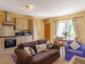 a living room with a couch and a table at Curlew Cottage in Hexham