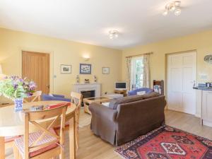 a living room with a couch and a table at Curlew Cottage in Hexham +7 photos