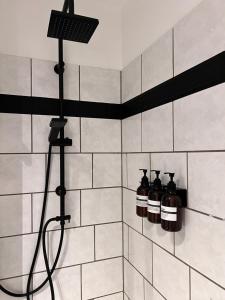 a shower with two bottles on the wall at V & S Apartments Since 2023 in Düsseldorf