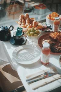 a table with plates of breakfast food on it at Palm Beach in Ajaccio