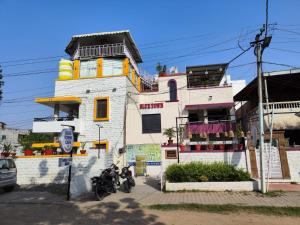 a building with two motorcycles parked in front of it at Blue town Hostel & Cafe in Jodhpur