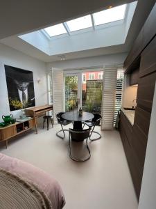 a bedroom with a skylight and a table at B&B Urban Oasis in Amsterdam