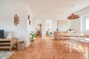 a living room with a table and a dining room at Beato Tagus River View in Lisbon