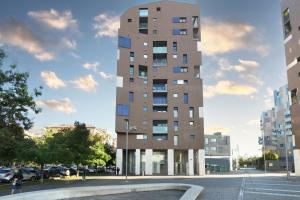 un grand bâtiment au milieu d'une rue dans l'établissement Contempora Apartments - trilocale Largo Zanuso, à Milan