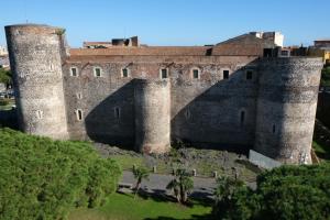 an old castle with two towers and a yard at Central Apartment with Panoramic Terrace in Catania