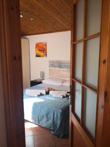two beds in a room with a door open at A due passi dal mare in Varazze