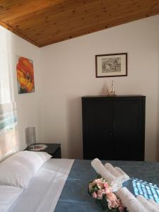 a bedroom with a bed with two towels on it at A due passi dal mare in Varazze