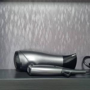 a black hair dryer sitting on top of a table at Stay Colorido in Siheung