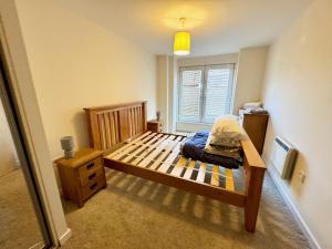 a small bedroom with a bed and a window at Elvetham Nest Guesthouse, Basingstoke in Basingstoke