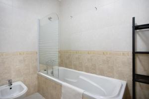 a bathroom with a bath tub and a sink at A O - Ferrel House Casual in Ferrel +17 photos