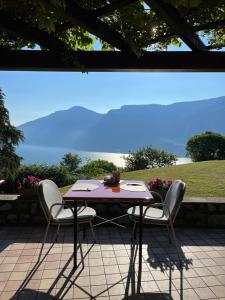 a table and chairs on a patio with a view at Villa Selene in Tremosine Sul Garda