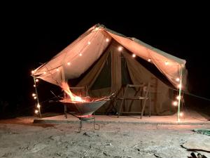 a large tent with lights in the dark at Kambu Mara Camp in Sekenani