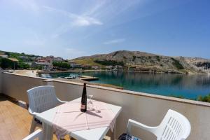 a bottle of wine sitting on a table on a balcony at Dubravko in Metajna