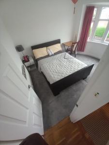 een slaapkamer met een bed in het midden van een kamer bij Morgan Ease in Manchester