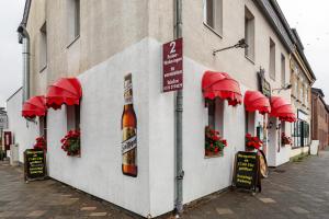 a building with a bottle of beer on the side of it at Tapas Restaurante 2 in Viersen