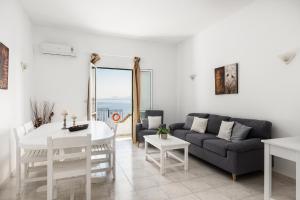 a living room with a couch and a table at Four-Bedroom Villa Eleni by Konnect, with Private Pool & Stunning Seaview in Barbati