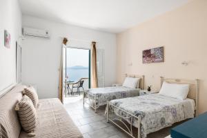a room with two beds and a view of the ocean at Four-Bedroom Villa Eleni by Konnect, with Private Pool & Stunning Seaview in Barbati +21 photos