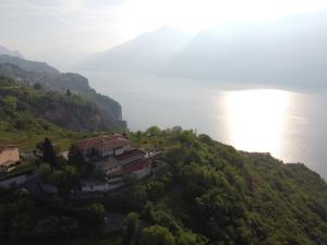 a house on a hill next to the water at Villa Selene in Tremosine Sul Garda