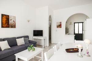 a living room with a couch and a table at Four-Bedroom Villa Eleni by Konnect, with Private Pool & Stunning Seaview in Barbati