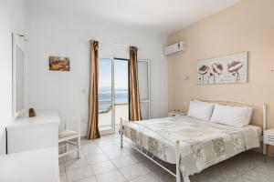 a bedroom with a bed and a view of the ocean at Four-Bedroom Villa Eleni by Konnect, with Private Pool & Stunning Seaview in Barbati
