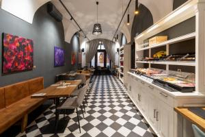 a restaurant with a black and white checkered floor at Hotel Ikona in Prague