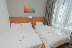 Postel nebo postele na pokoji v ubytování Ipoh Tambun Sunway Onsen Suite 3R2B Maya