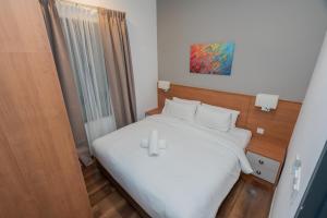 een slaapkamer met een wit bed met twee kaarsen erop bij Ipoh Tambun Sunway Onsen Suite 3R2B Maya in Tambun