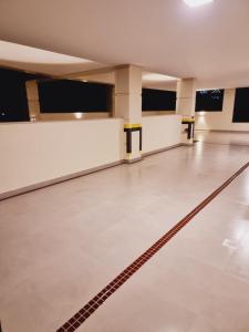an empty bowling alley with a lane in the middle at Privillege Residence 02 in Bombinhas
