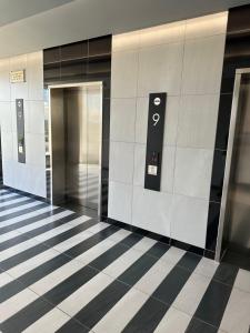 a hallway with two elevators in a building at Menylyn Maine Residences Trilogy 913 in Pretoria
