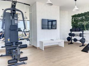 een kamer met een fitnessruimte met een tv en gewichten bij Via Celere 2335 Golf & Sea view in Casares