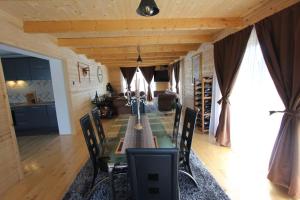 a dining room with a long table and chairs at Holiday house - Berane in Berane