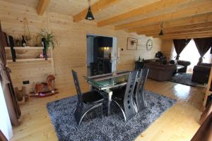 a living room with a glass table and chairs at Holiday house - Berane in Berane
