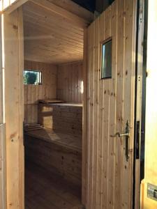 a wooden sauna with a wooden floor and a door at Apartamenty Grosik in Krynica Zdrój