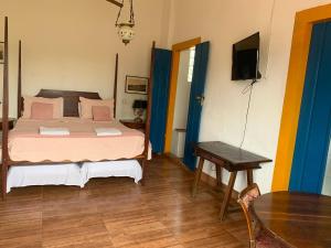 Postel nebo postele na pokoji v ubytování Suítes Casa da Colônia