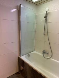 a bathroom with a shower and a tub at Weidach Zentrum in Leutasch