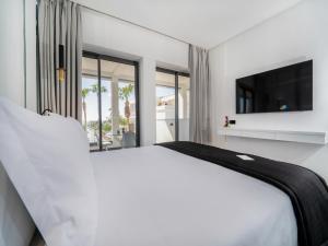 Postel nebo postele na pokoji v ubytování Petit Palace Suites Hotel