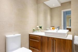 a bathroom with a white sink and a toilet at Beaufort Gardens Apartment in Knightsbridge in London