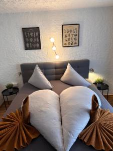 a bed with two pillows on top of it at Weidach Zentrum in Leutasch